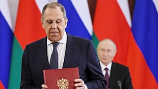 FILE: Russian Foreign Minister Sergey Lavrov attends a signing ceremony with Russian President Vladimir Putin in the background, in Moscow, 22 April 2025